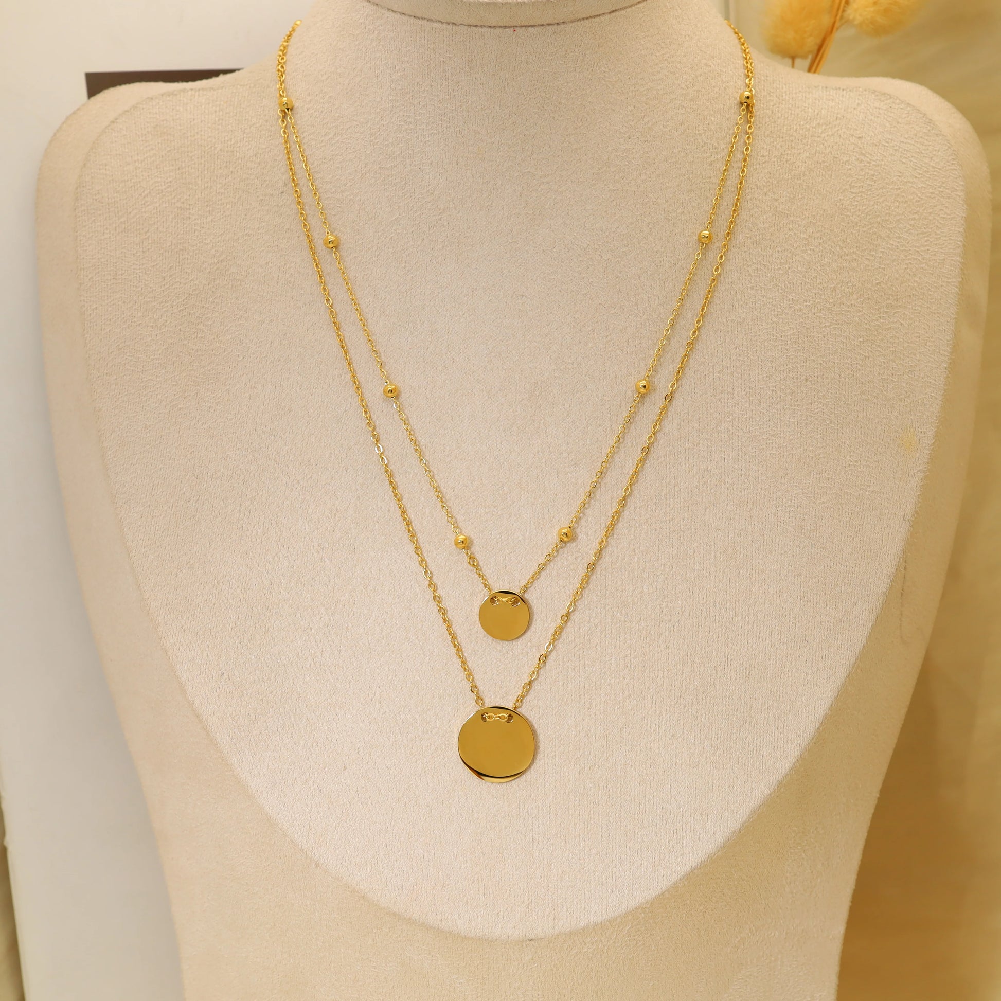 Collier double chaîne avec pendentifs ronds