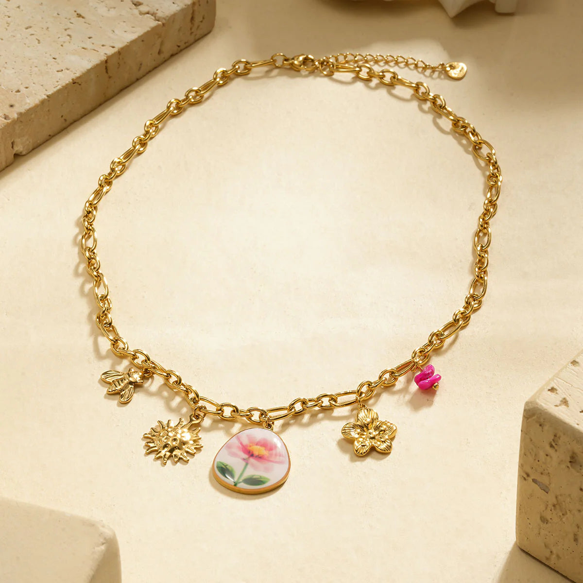 Collier chaîne dorée avec breloques fleur dessinée
